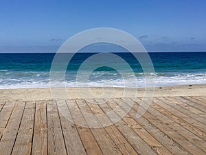 Blue ocean, sand, and Boardwalk