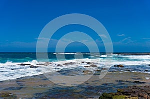 Blue ocean surface and clear sky. Summertime vacation background