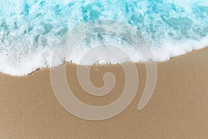 Blue ocean waves with white foam crashing on summer sand beach island top view with copy space, beautiful natural scene of