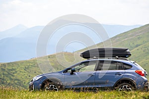 Blue off road car on mountain trail. Traveling by auto, adventure in wildlife, expedition or extreme travel on SUV