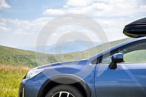 Blue off road car on mountain trail. Traveling by auto, adventure in wildlife, expedition or extreme travel on SUV