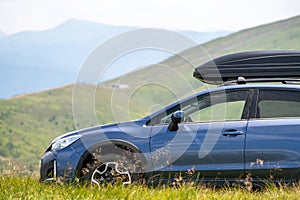 Blue off road car on mountain trail. Traveling by auto, adventure in wildlife, expedition or extreme travel on SUV