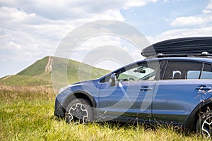 Blue off road car on mountain trail. Traveling by auto, adventure in wildlife, expedition or extreme travel on SUV