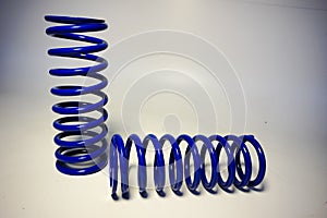 blue off-road suspension springs on a white background