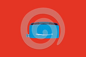 Blue office hole puncher on red background