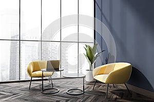 Blue office seating area with two yellow armchairs