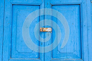 Blue old door with paddle key lockset.