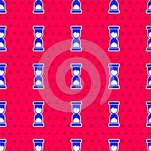 Blue Old hourglass with flowing sand icon isolated seamless pattern on red background. Sand clock sign. Business and