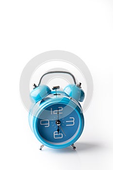 Blue old style alarm clock on white background