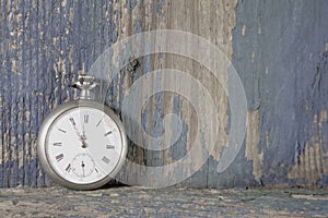 Blue old wooden background with a old pocket watch