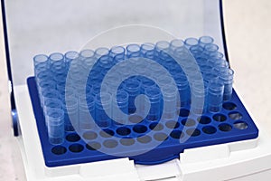 Blue one millilitre pipette tips in the box. Chemical laboratory.