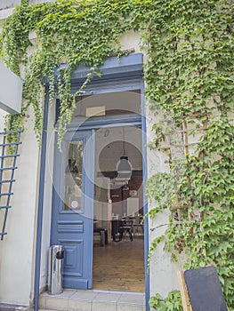 blue open door ivy covered with view on vintage industrial cofee bar