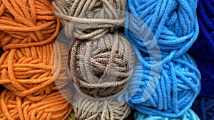 Blue, orange and brown range of wool yarn.