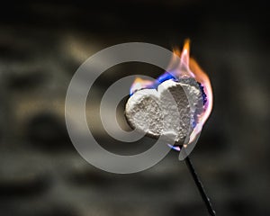 Blue and Orange Flames Glowing on a Heart Shaped Marshmallow