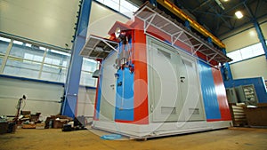 Blue and orange substation in workshop of refinery plant
