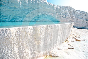 Blue outdoor pool in white rock. Natural travertine pools at Pamukkale or Cotton castle, Turkey