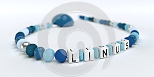 A blue pacifier chain for boys with name Linus