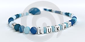 A blue pacifier chain for boys with name Lukas