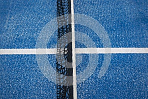 Blue paddle tennis net and court field background