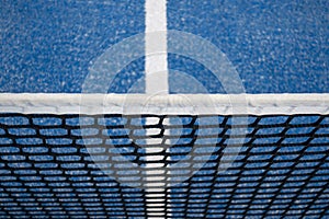 Blue paddle tennis net and court field background