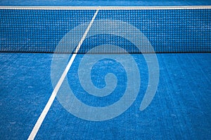 Blue paddle tennis net and court field background