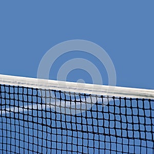 Blue paddle and tennis net and hard court. Professional sport and tennis competition concept