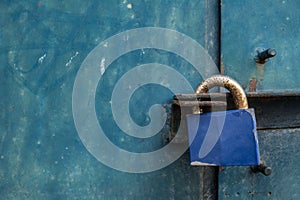 Blue padlock on steel door