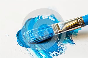 A blue paint brush on a white surface