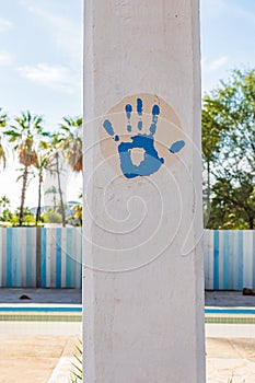 Blue paint handprint on a pillar in Baja