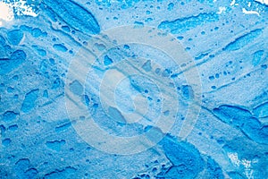 Blue paint spilled white background bubbled cream