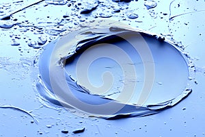 blue paint splashes on a blue background. close-up.