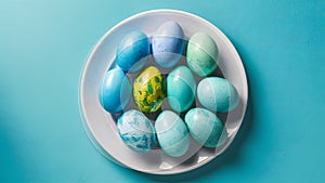 Blue painted eggs arranged on plate, top view Easter composition