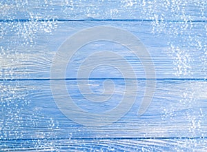 Blue painted old wooden background, winter frame snow