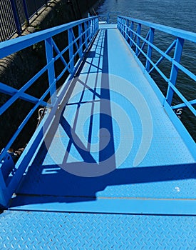 Blue painted steel boat gangway on the Rhine Germany