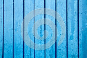 Blue painted wooden wall plank perpendicular to the frame as simple saturated blue oil paint timber wood background