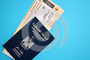Blue Palestinian Authority passport with airline tickets on blue background close up