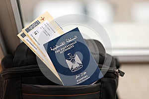 Blue Palestinian Authority passport with airline tickets on touristic backpack close up