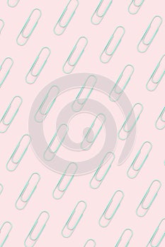 Blue paper clip flat lay on pink background