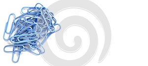 A blue paper clip on a white background close-up. Wide view. Top view, flat lay, place for text, copy space