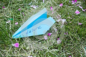 Blue paper plane with the word future. The concept dreams of the future