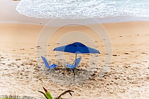 Blue parasol on the sand of Paciencia beach in the Rio Vermelho photo