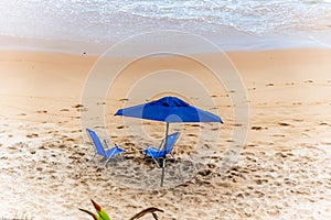 Blue parasol on the sand of Paciencia beach in the Rio Vermelho photo