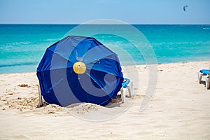 Blue parasol on sandy beach