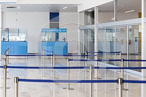 Blue passport control cabines at the empty airport terminal