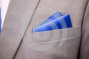 Blue pattern handkerchief close up in grey suit