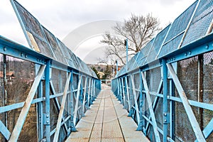 Blue pedestrian bridge over railroad