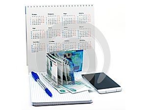 Blue pen and Notepad on a white background, phone and money, Russian money and calendar