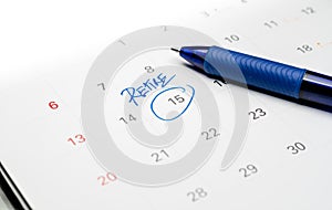 Blue Pen write the Word Retire on White Calendar