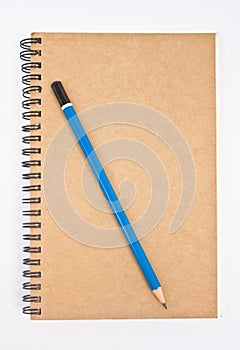 Blue pencil on brown notebook's cover.