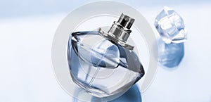 Blue perfume bottle on glossy background, sweet floral scent, glamour fragrance and eau de parfum as holiday gift and luxury